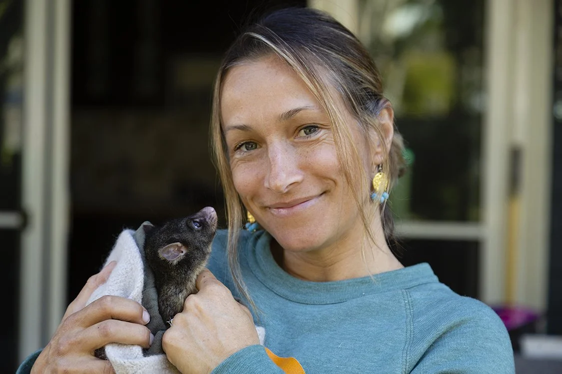 Green Heroes researcher holding a rescued possum